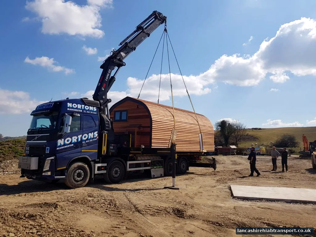 Hiab lorry lifting a portable pod for work serving Leyland