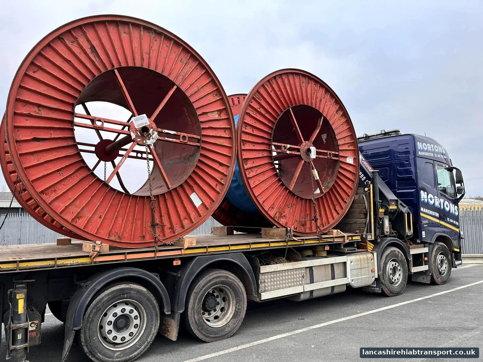 Hiab lorry transporting cable drums for work serving Preston