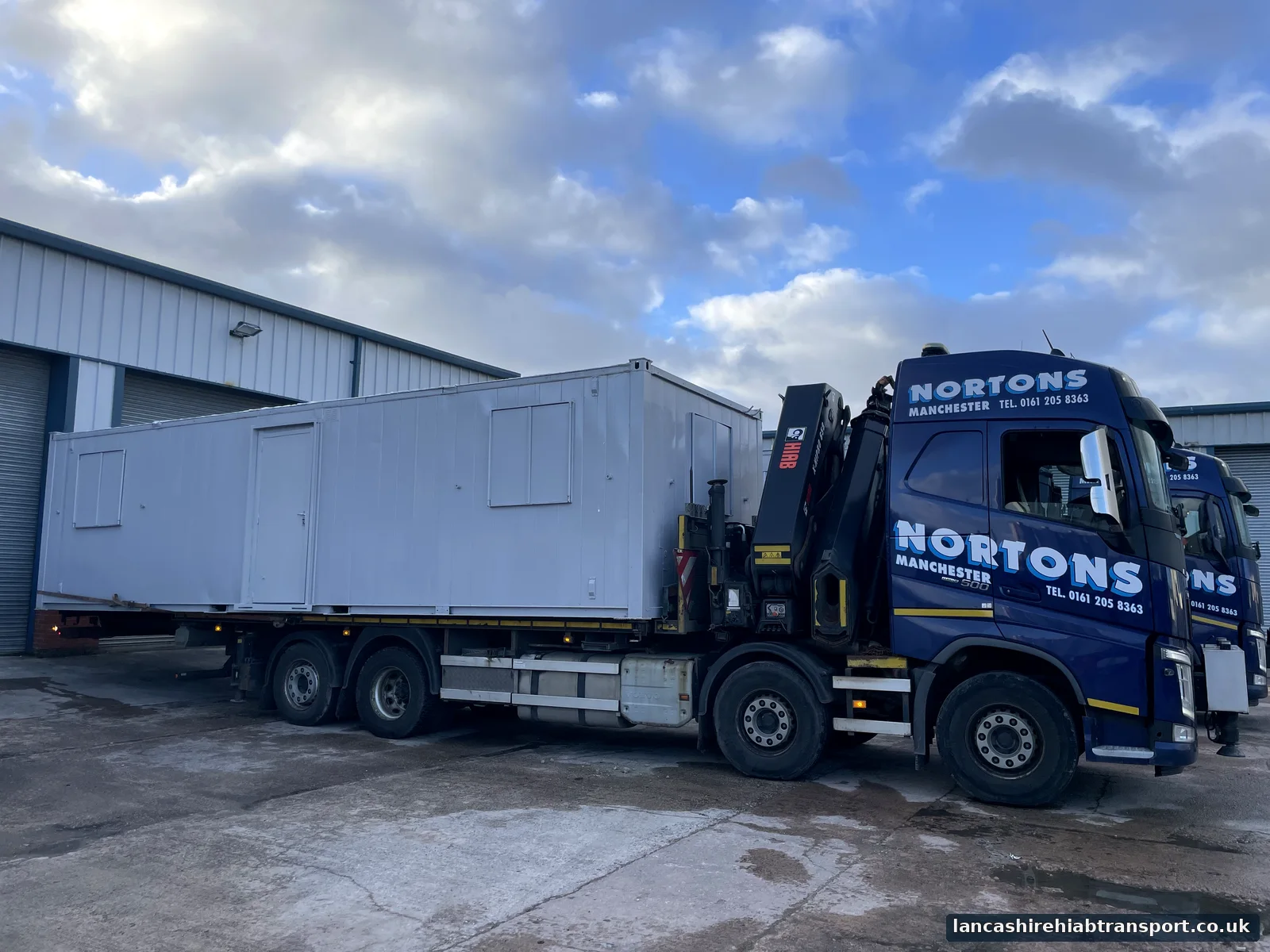 Hiab lorry delivering a portable cabin for work serving Darwen