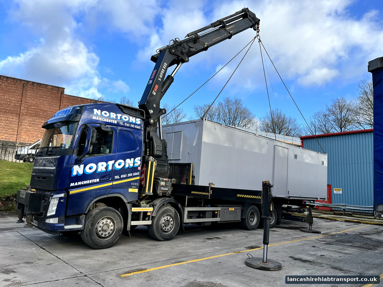Lancashire Hiab Transport crane lorry lifting a portable cabin