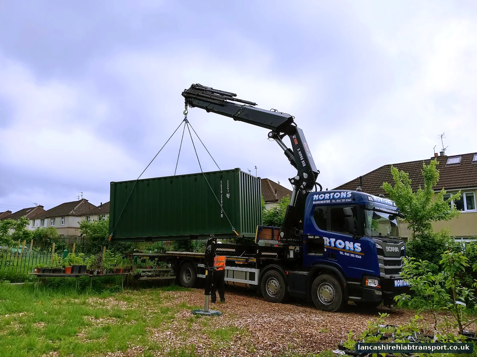 Hiab lorry lifting a shipping container