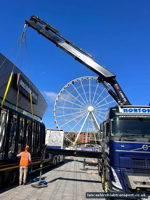 Hiab lorry lifting a portable cabin near Blackpool seafront