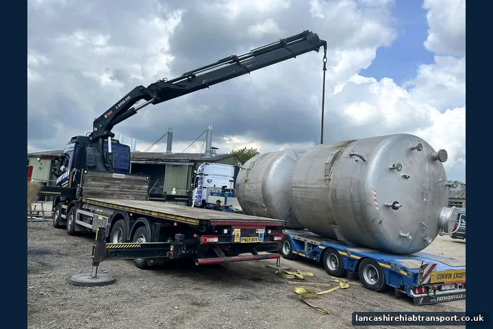 Crane-assisted haulage transporting an industrial tank