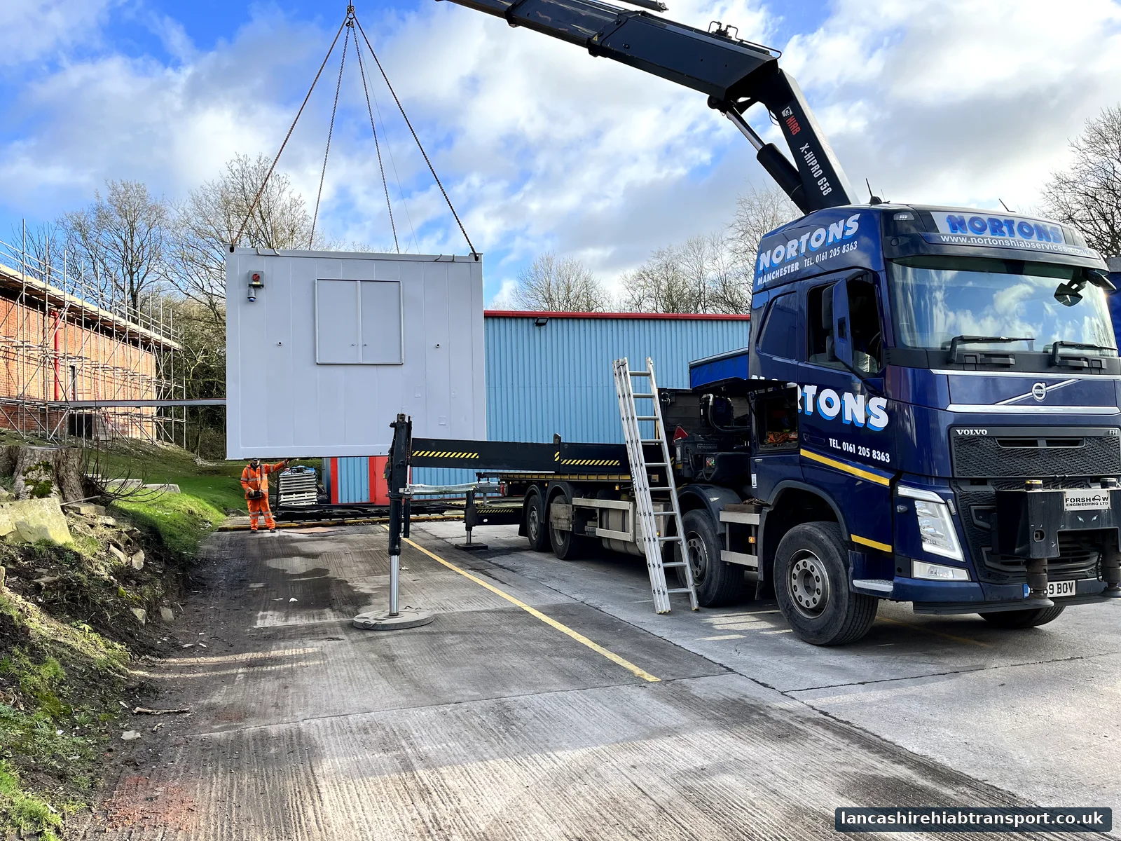 Lancashire Hiab Transport lorry positioning a portable cabin